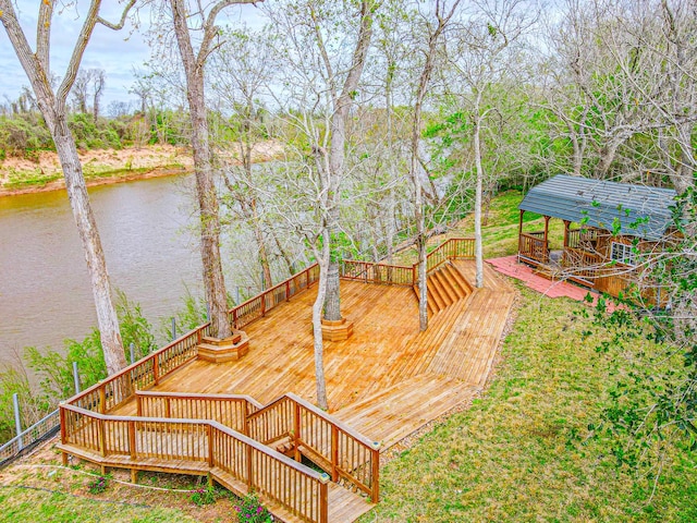 wooden terrace featuring a water view