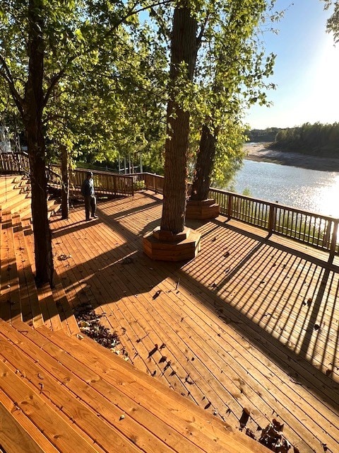 wooden deck featuring a water view