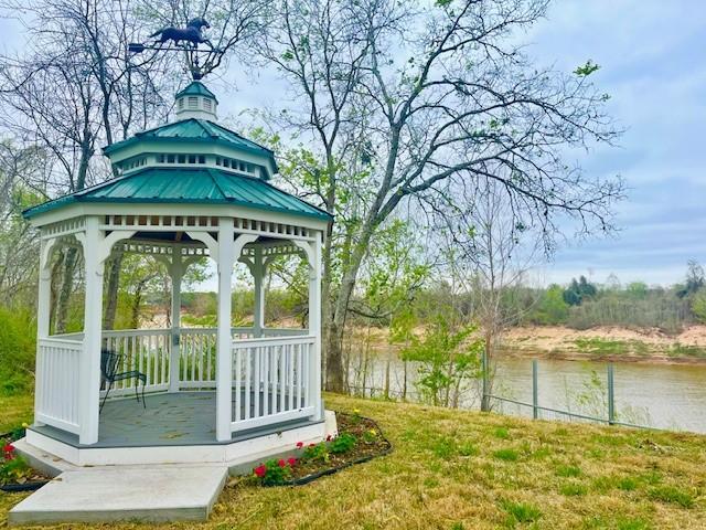 view of yard with a gazebo and a water view