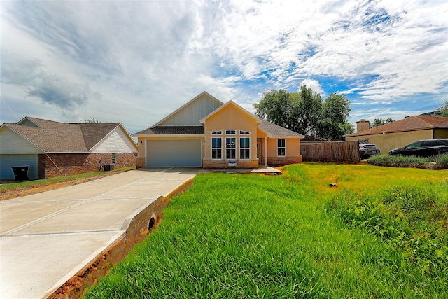 view of front of home with a front lawn, fence, board and batten siding, concrete driveway, and a garage