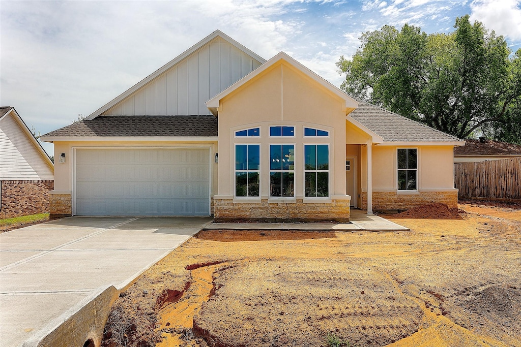 12522 Ridgecrest, Willis, TX 77318 - single story home featuring concrete driveway, an attached garage, stone siding, and a shingled roof