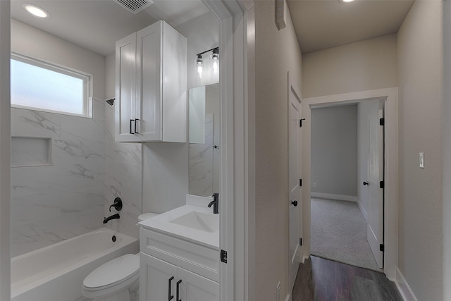 bathroom with vanity, wood finished floors, washtub / shower combination, visible vents, and toilet