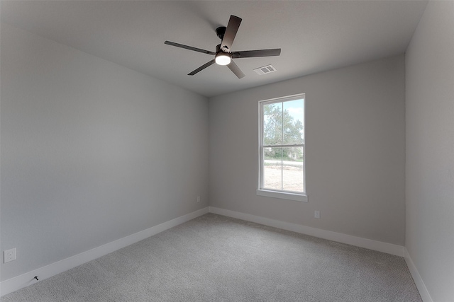 unfurnished room featuring visible vents, baseboards, light colored carpet, and a ceiling fan