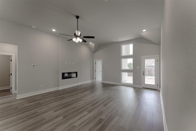 unfurnished living room with a ceiling fan, wood finished floors, baseboards, recessed lighting, and a fireplace