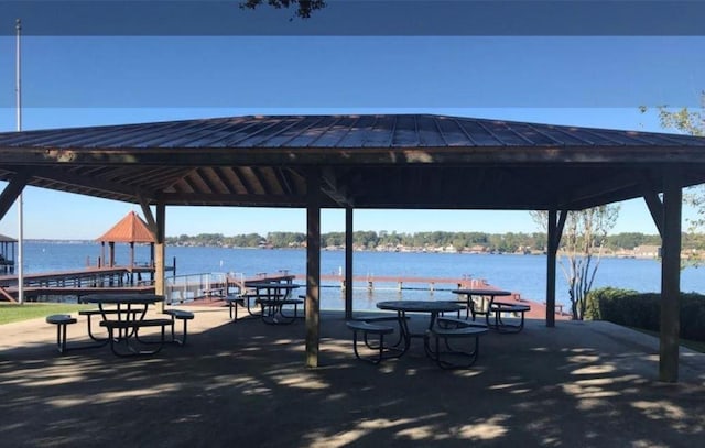 surrounding community with a gazebo and a water view