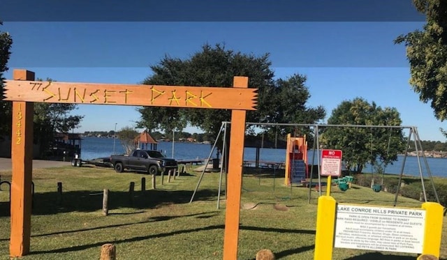 communal playground with a water view and a lawn