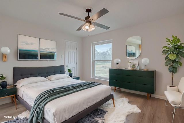 bedroom with ceiling fan and light wood-type flooring