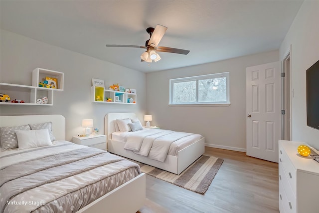 bedroom with ceiling fan and light hardwood / wood-style flooring