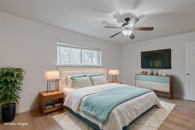 bedroom with ceiling fan and light hardwood / wood-style floors