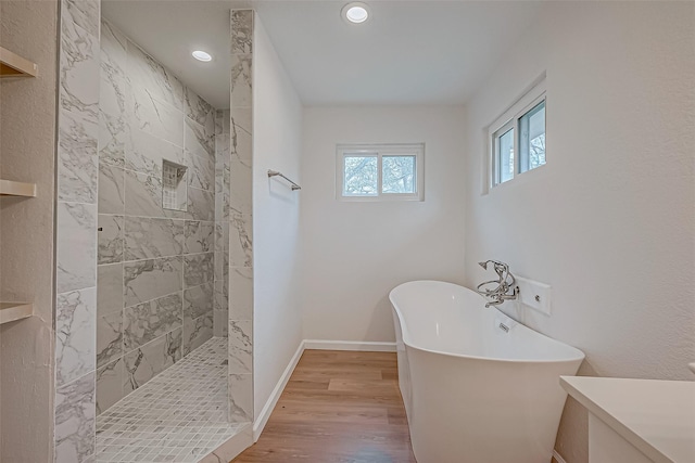 bathroom with vanity, wood-type flooring, and independent shower and bath