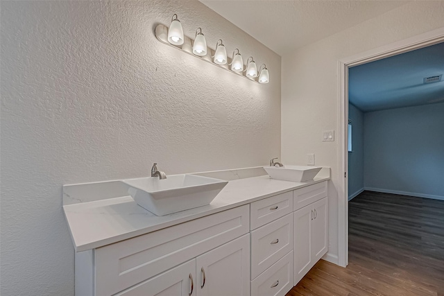 bathroom featuring hardwood / wood-style flooring and vanity