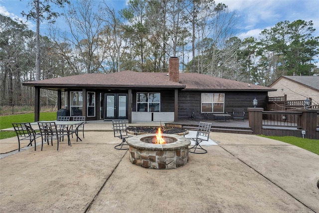 back of house with french doors, a patio area, and an outdoor fire pit