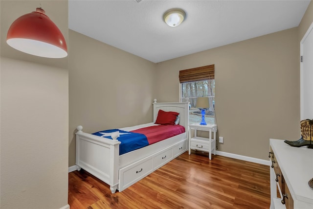 bedroom with hardwood / wood-style floors