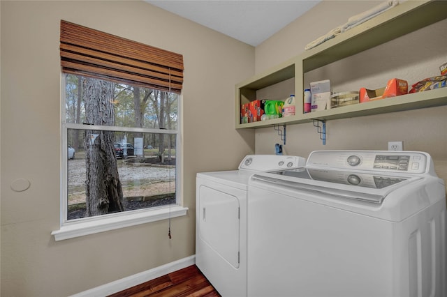 washroom featuring washing machine and dryer and dark wood-type flooring