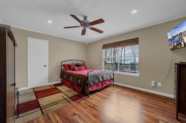 bedroom featuring ornamental molding, hardwood / wood-style floors, and ceiling fan