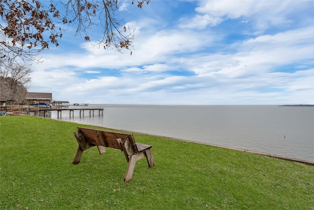 exterior space with a water view and a yard