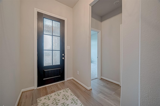 entryway with baseboards and light wood-type flooring