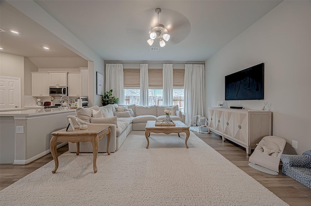 living room with recessed lighting, ceiling fan, and wood finished floors