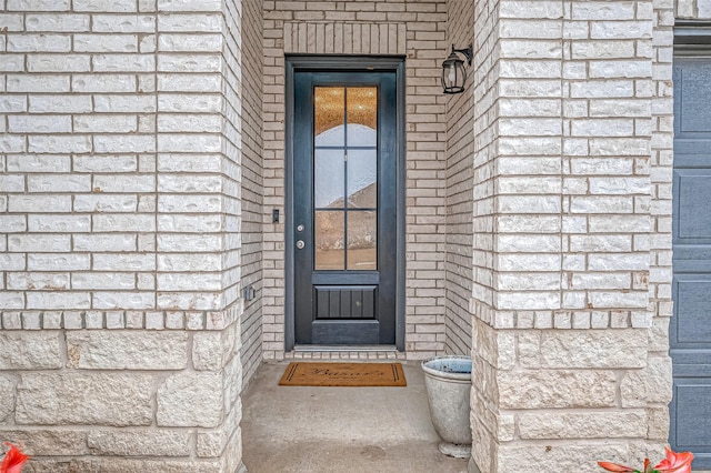 property entrance with brick siding