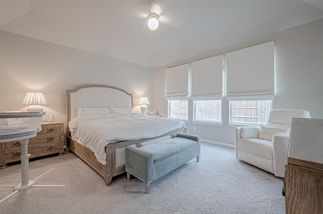 bedroom with baseboards and light colored carpet