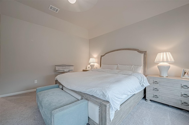 bedroom featuring visible vents, baseboards, and light carpet