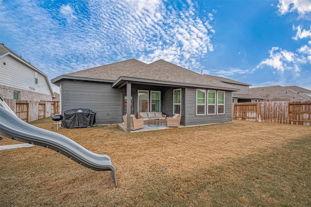 rear view of property with roof with shingles, outdoor lounge area, a fenced backyard, a playground, and a yard