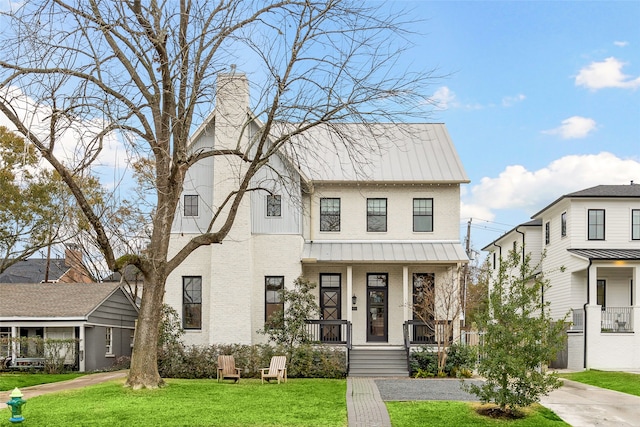 view of front of house featuring a front yard and covered porch