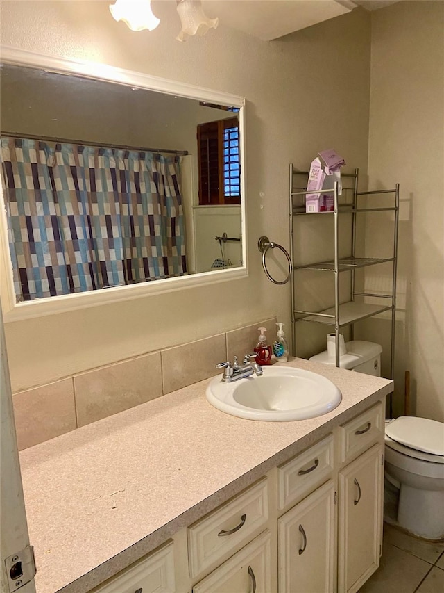 bathroom featuring vanity, tile patterned flooring, curtained shower, and toilet