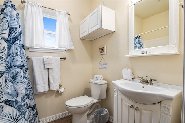 bathroom with vanity, toilet, tile patterned floors, and walk in shower