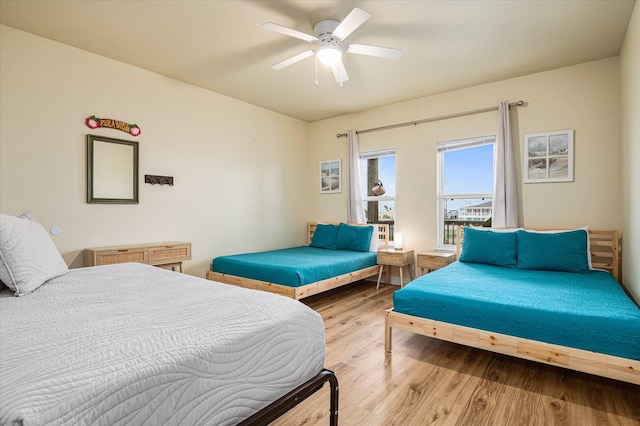 bedroom with ceiling fan and light hardwood / wood-style flooring