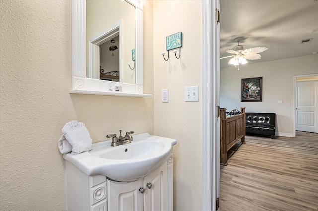 bathroom with vanity, ceiling fan, and wood-type flooring