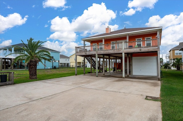 coastal inspired home with a garage, a carport, covered porch, and a front lawn