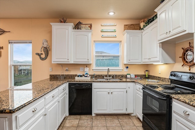 kitchen featuring kitchen peninsula, black appliances, sink, dark stone counters, and white cabinets