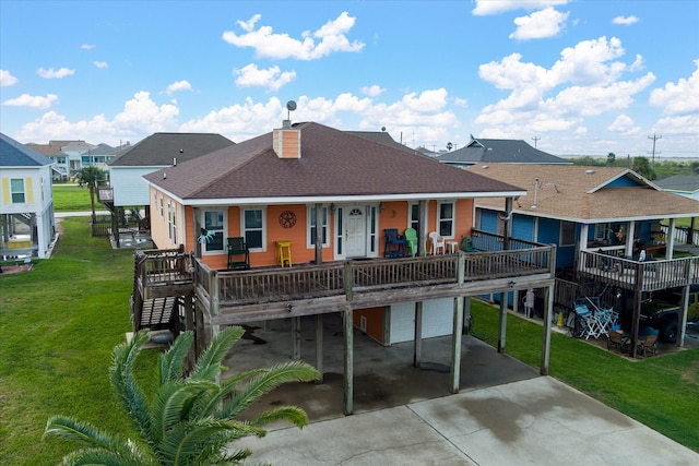 rear view of house with a yard, a porch, and a garage