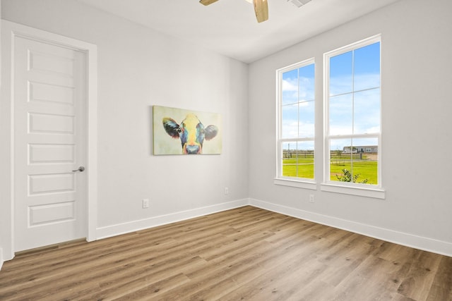 unfurnished room featuring ceiling fan and light wood-type flooring