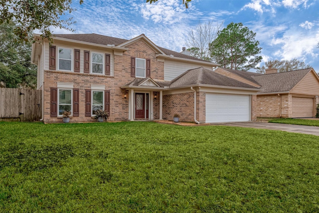 view of front of home with a garage and a front lawn