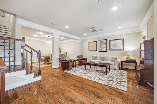 living room with ceiling fan, ornamental molding, hardwood / wood-style floors, and ornate columns