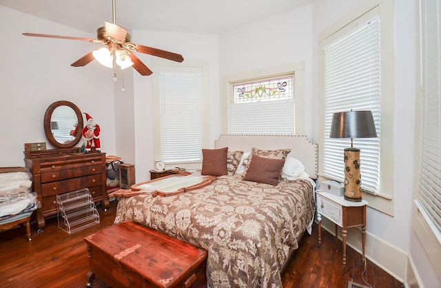 bedroom with ceiling fan and dark hardwood / wood-style floors