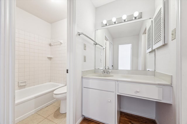 full bathroom with tile patterned floors, vanity, toilet, and tiled shower / bath combo