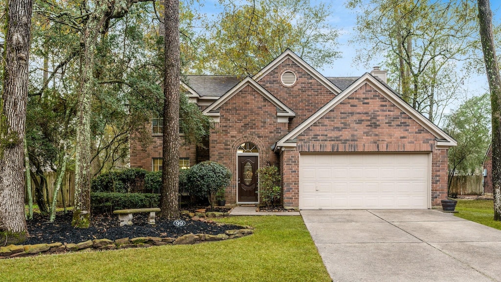 view of front of home featuring a garage and a front yard