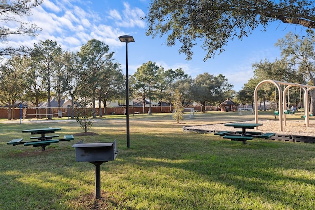 view of property's community with a yard and a playground