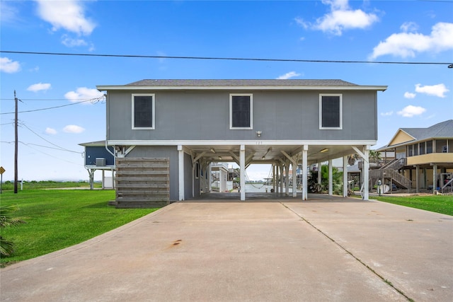 view of front of property with a front lawn and a carport