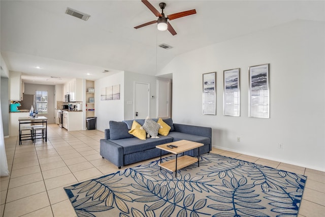 tiled living room featuring lofted ceiling and ceiling fan