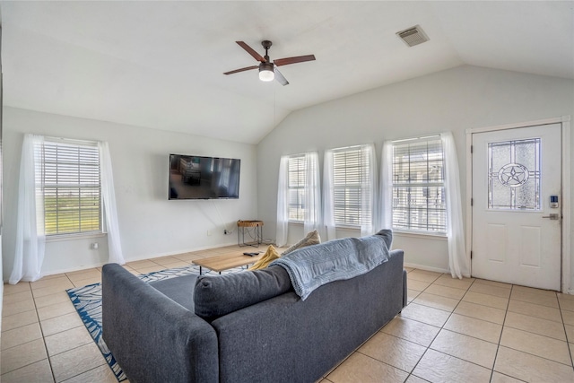 living room with ceiling fan, vaulted ceiling, and light tile patterned floors