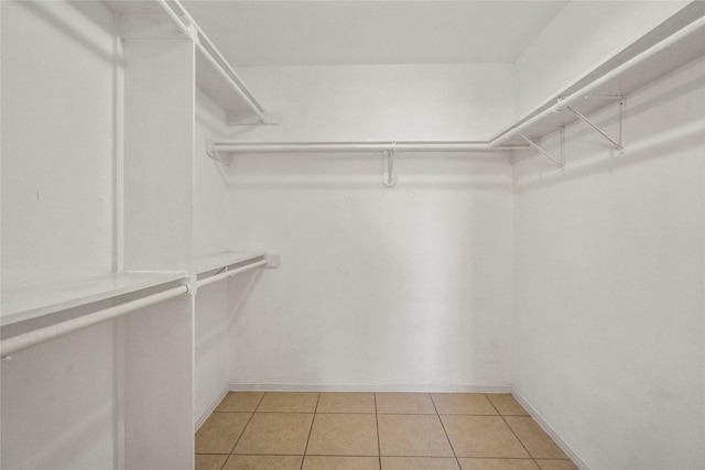 spacious closet with light tile patterned floors