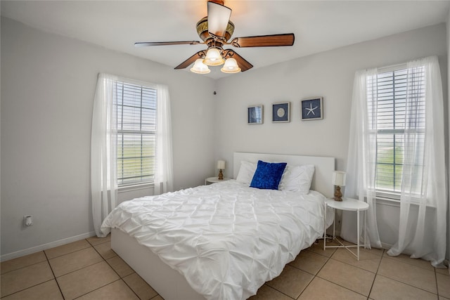 tiled bedroom featuring ceiling fan