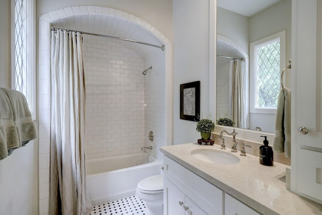 full bathroom featuring shower / bath combination with curtain, vanity, and toilet