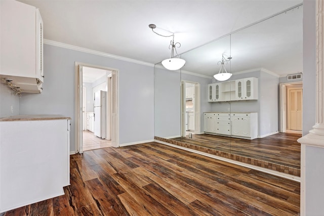 interior space with ornamental molding and dark hardwood / wood-style floors