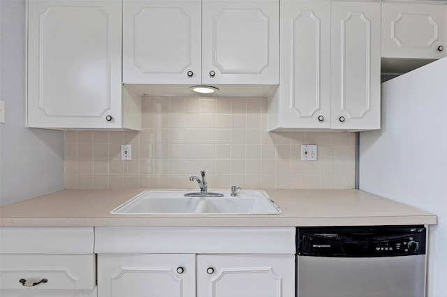 kitchen featuring tasteful backsplash, sink, stainless steel dishwasher, and white cabinets