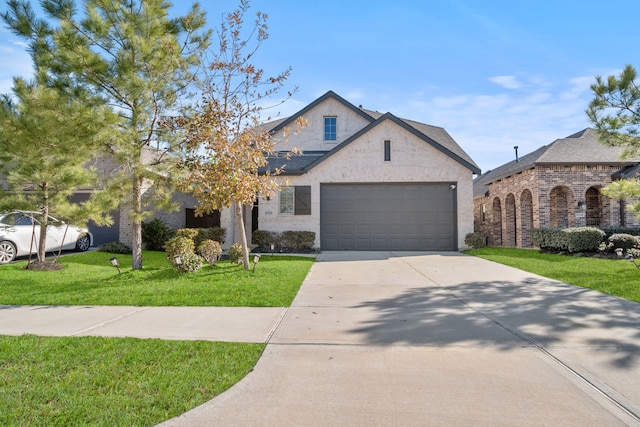 view of front of house with a garage and a front yard